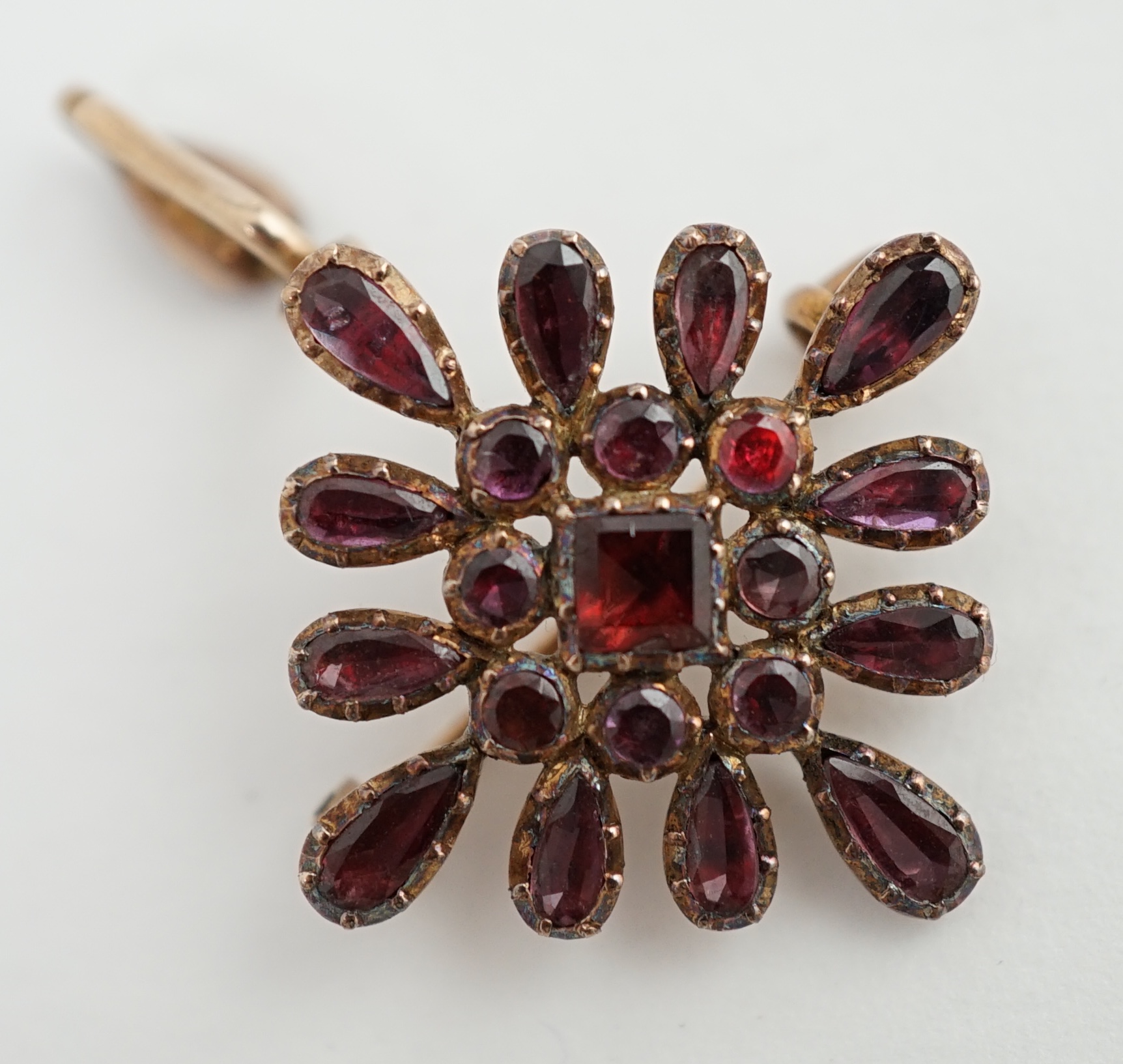 An early Victorian gold and garnet cluster set drop pendant brooch